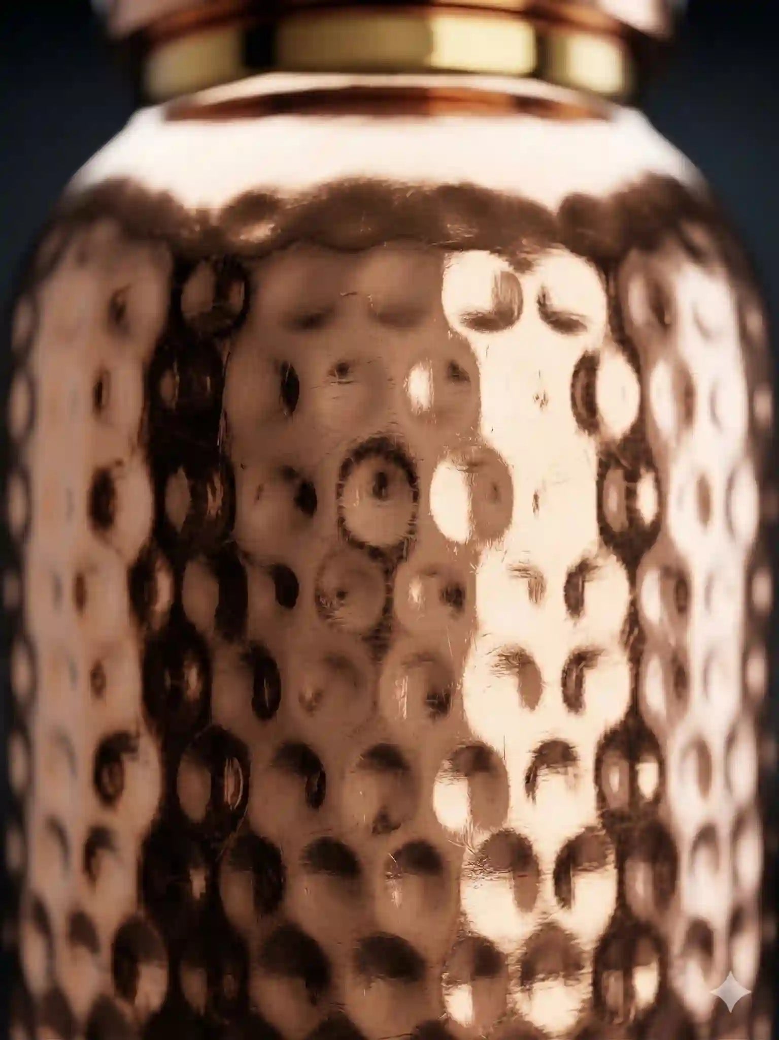 Close-up of hammered copper texture on Cupreva bottle showing premium handcrafted finish