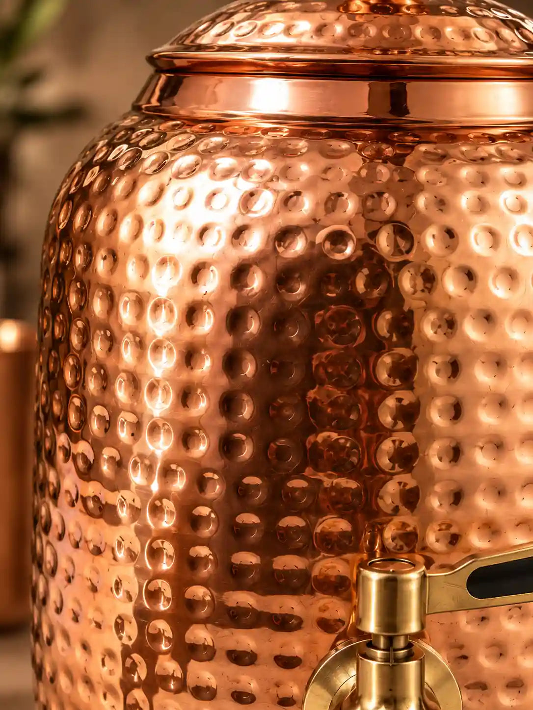 Close-up of hand-hammered pure copper texture on water dispenser
