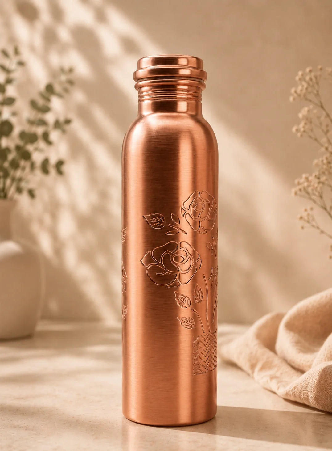 Magic color changing pure copper water bottle with floral engraved design for healthy Ayurvedic drinking water