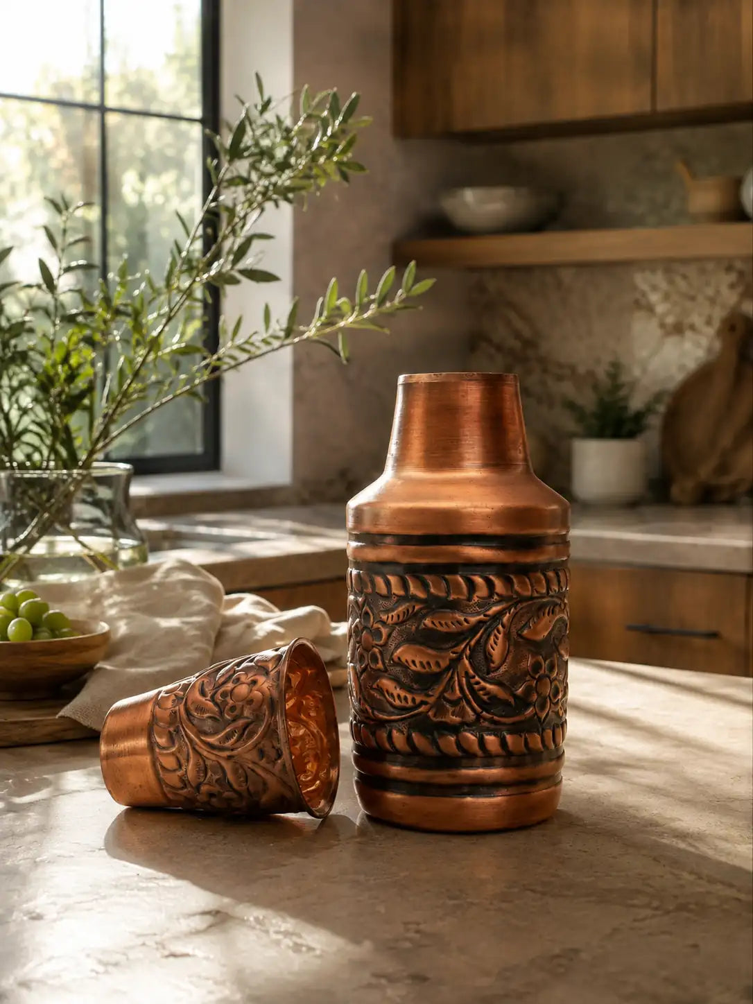 Handcrafted pure copper water carafe with embossed floral design in a luxury kitchen